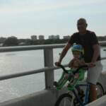 Avery (2) & Daddy enjoying the sights of Longboat Key on one of our Men's Cruisers with a Front-Mounted Child Seat.