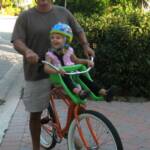 Brielle (3) going for a ride in one of our Front-Mounted Child Seats on a Men's Beach Cruiser.